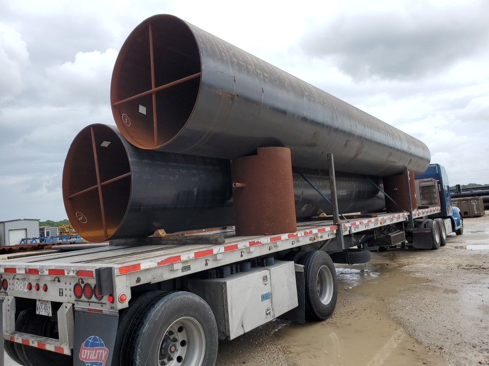 Large OD X56 Carbon Steel API pipe Loaded onto a truck with Pipe Saddles